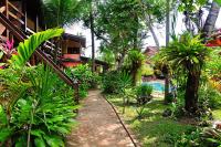 a path leading to a resort with a swimming pool at Hotel Pousada Marambaia in Arraial d'Ajuda
