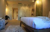a bedroom with a large bed and a bathroom at Les Suites Massena in Nice