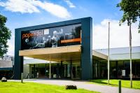 a building with a large sign on the side of it at Hotel Papendal in Arnhem