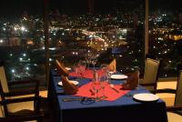 una mesa con copas de vino y vistas a la ciudad en Radisson Hotel Trinidad, en Puerto España