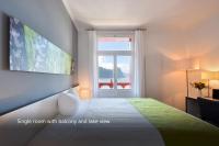 Postel nebo postele na pokoji v ubytování Hotel Vitznauerhof - Lifestyle Hideaway at Lake Lucerne