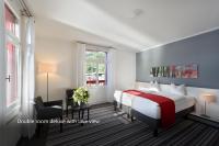 Postel nebo postele na pokoji v ubytování Hotel Vitznauerhof - Lifestyle Hideaway at Lake Lucerne