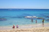 a group of people playing in the water at the beach at Hang Hai B&amp;B in Eluan