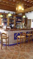 a bar with three chairs and a counter with a counter at Hotel Posada Casas Viejas in Benalup Casas Viejas