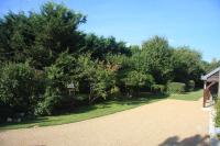 a garden with trees and a driveway at Les Bouts de Rallé Chambre d&#39;Hotes in Sainte-Osmane