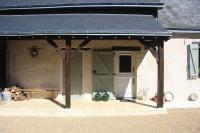 a covered entry to a house with a roof at Les Bouts de Rallé Chambre d&#39;Hotes in Sainte-Osmane