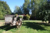 a wooden cart with flowers on it in a field at Les Bouts de Rallé Chambre d&#39;Hotes in Sainte-Osmane