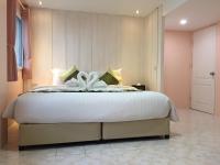 a bedroom with a bed with a white flower on it at Samui Green Hotel in Chaweng