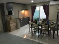 a kitchen and dining room with a table and chairs at Samui Green Hotel in Chaweng
