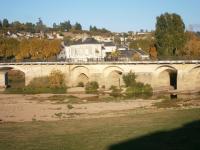 a bridge over a river with a town in the background at Chez Elisa in Chinon