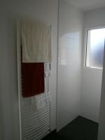 a bathroom with a shower with towels and a window at Chez Elisa in Chinon