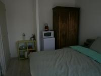 a small bedroom with a bed and a microwave at Chez Elisa in Chinon