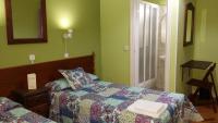 A bed or beds in a room at Hostal San Martin