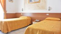 Posteľ alebo postele v izbe v ubytovaní Hotel Mignon