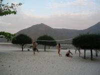 a group of people playing volleyball on the beach at Malibu Beach Bungalows in Chaloklum