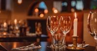 a group of wine glasses and a candle on a table at Original Sokos Hotel Vaakuna Rovaniemi in Rovaniemi