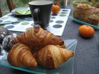 a table with a plate of croissants and a cup of coffee at Les Chambres de l&#39;Ile in Metz