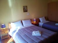 A bed or beds in a room at Hotel Aoos