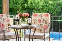 a table with a bottle of wine and a vase of flowers at Lares De Chacras in Chacras de Coria