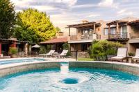 a swimming pool in front of a house at Lares De Chacras in Chacras de Coria