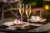 a table with a plate of food and two glasses of wine at Lares De Chacras in Chacras de Coria
