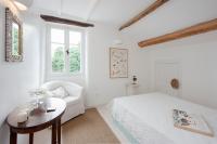 A bed or beds in a room at White Jasmine Cottage