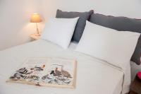 A bed or beds in a room at White Jasmine Cottage