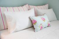 A bed or beds in a room at White Jasmine Cottage