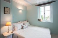 A bed or beds in a room at White Jasmine Cottage