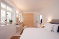 A bed or beds in a room at White Jasmine Cottage