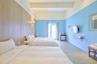 two beds in a room with blue walls at Love Summer Hostel in Hengchun South Gate