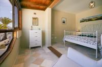 A bed or beds in a room at Villa Palmeras Beach Puerto del Carmen