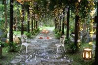 a garden with chairs and a table and lights at Country Grange B&amp;B in Yuanshan