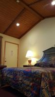 a bedroom with a bed with a lamp on a table at Atlantic Motel in Point Pleasant Beach