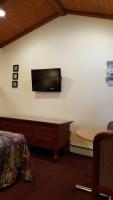 a room with a flat screen tv on the wall at Atlantic Motel in Point Pleasant Beach