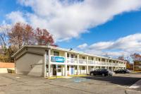a large white building with a sign on it at Motel 6 New Brunswick in New Brunswick