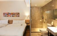 a hotel room with a bed and a shower at Miller Inn in Taichung