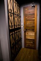 a room with a wooden door and a wooden floor at Silom Space Hostel in Bangkok