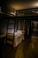 a bedroom with a bunk bed with a ladder at Silom Space Hostel in Bangkok