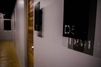 a hallway with black and white photographs on a wall at Silom Space Hostel in Bangkok
