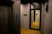 a door to a hallway with a sign on the wall at Silom Space Hostel in Bangkok