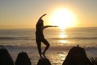 a person jumping on the beach at sunset at Dali Yi International Hostel in Toucheng