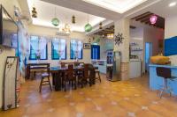 a kitchen and dining room with a table and chairs at Greek Wonderland B&amp;B in Hualien City