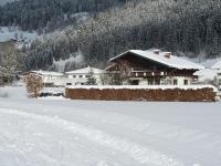 a house in the snow with footprints in the snow at Ferienwohnung Familie Wieser in Altenmarkt im Pongau