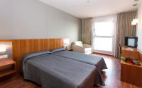 Postel nebo postele na pokoji v ubytování Hotel AG Express Elche