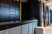a bar with black walls and a counter with a stool at The Tango Taichung in Taichung