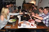 a group of people sitting at a table with a cake at Glamping at Camping La Source in Saint-Pierre-dʼArgençon