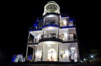 a tall building with a clock tower at night at Bliss Bed and Breakfast in Yuchi