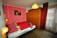 A bed or beds in a room at Garni Gimea