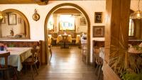 a dining room with an archway in a restaurant at Hotel Gasthof Rose in Oy-Mittelberg